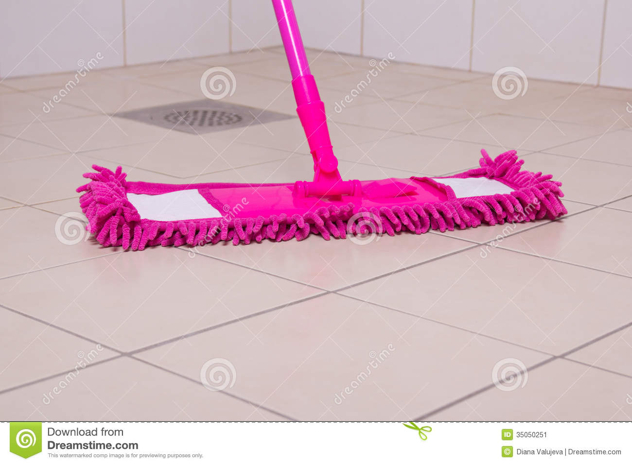 Pink Mop Cleaning Tile Floor In Bathroom