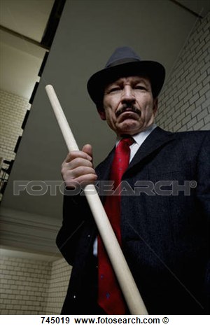 Stock Photograph Of An Organized Crime Boss Holding A Wood Rod 745019    