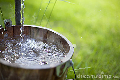 Clean Water From A Well Spills Out Into A Bucket  Shallow Depth Of
