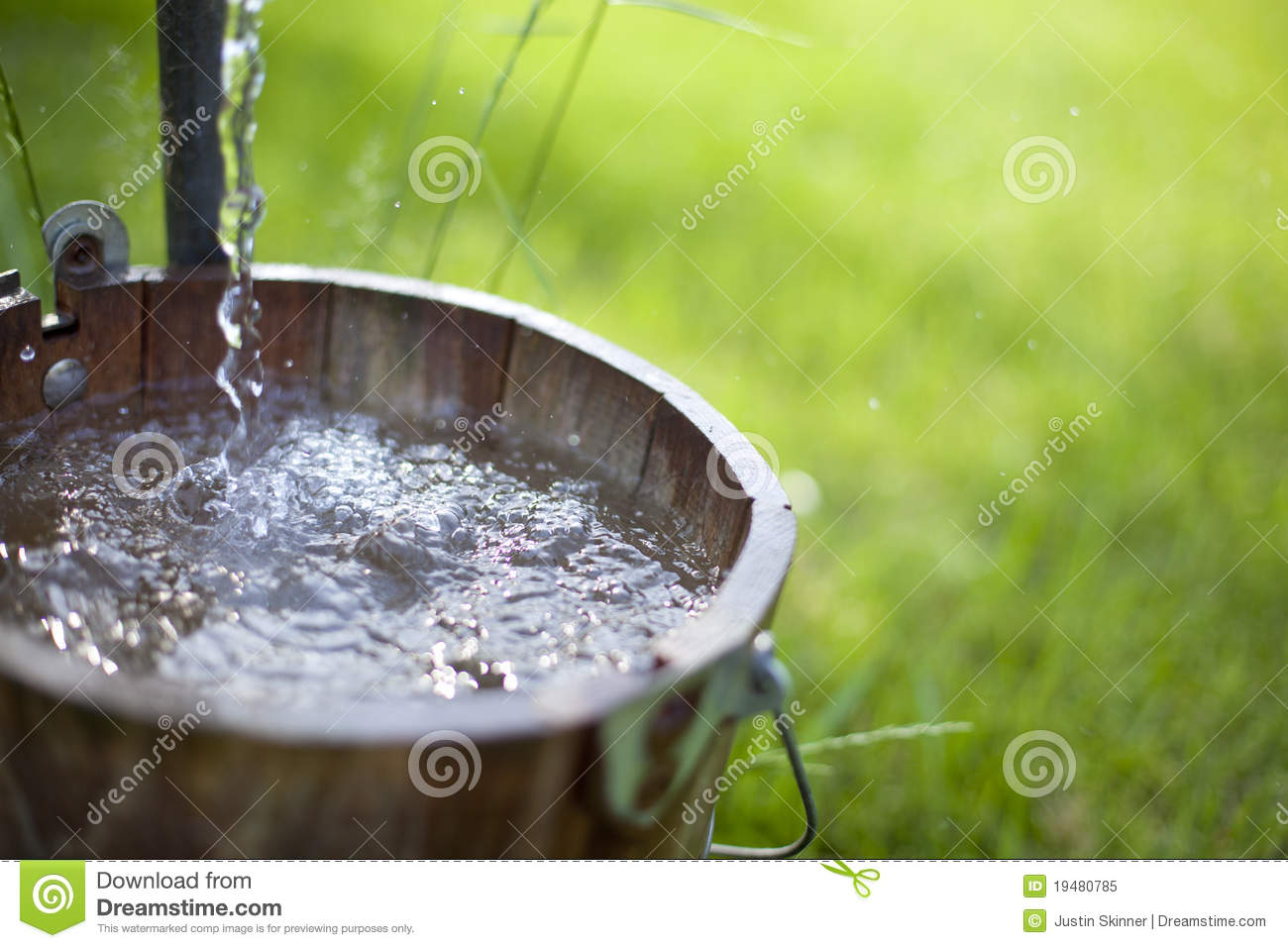 Clean Water From A Well Spills Out Into A Bucket  Shallow Depth Of    