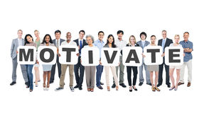 Multiethnic Group Of Business People Holding Word Motivate Stock