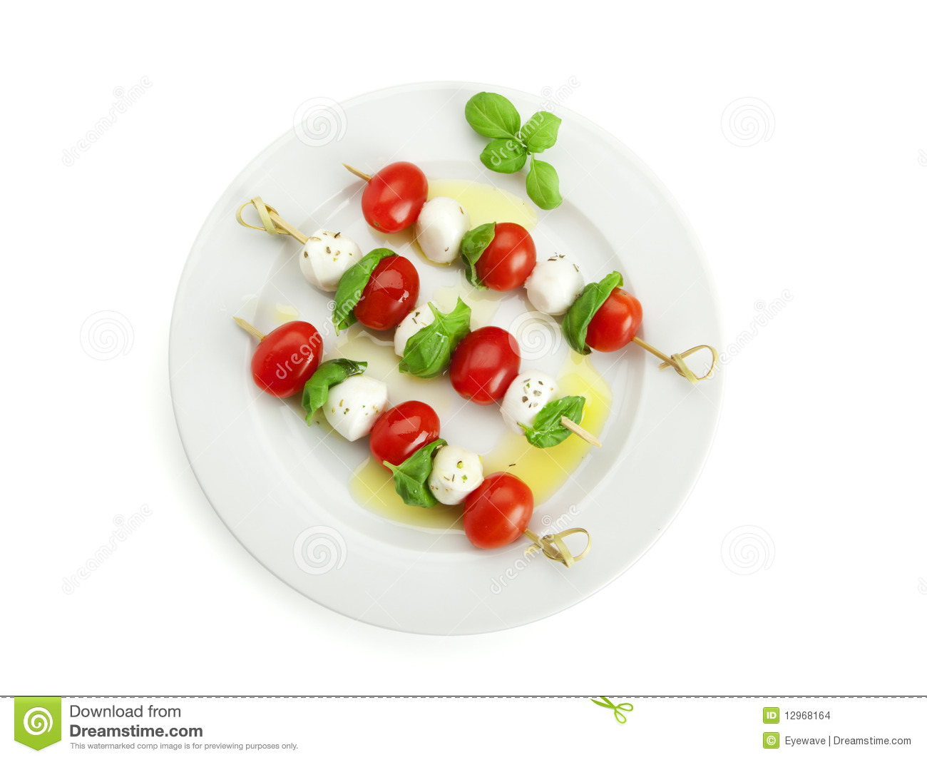 Three Sticks With Tomato Mozzarella And Basil On Round Plate Birds