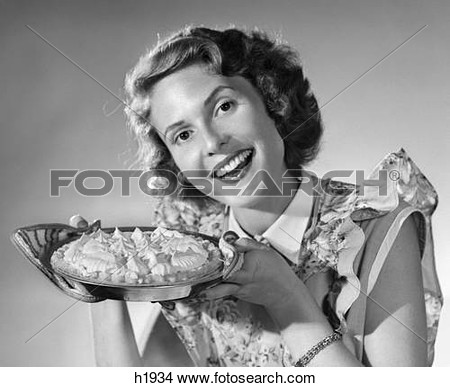 Stock Photo   1950s Smiling Woman Presenting Holding Freshly Baked Pie