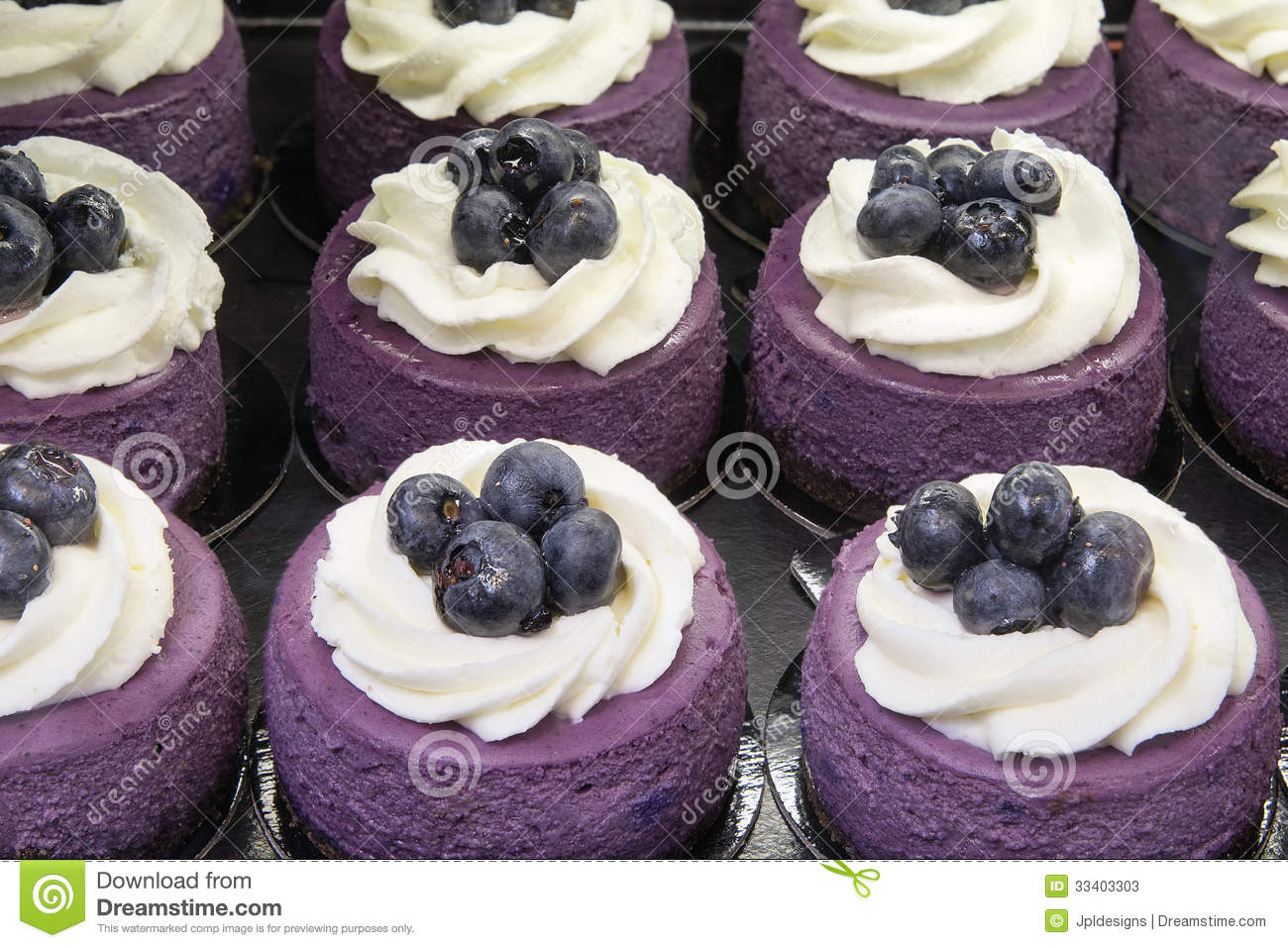 Blueberry Mousse Cake Topped With Blueberries And Whipped Cream At