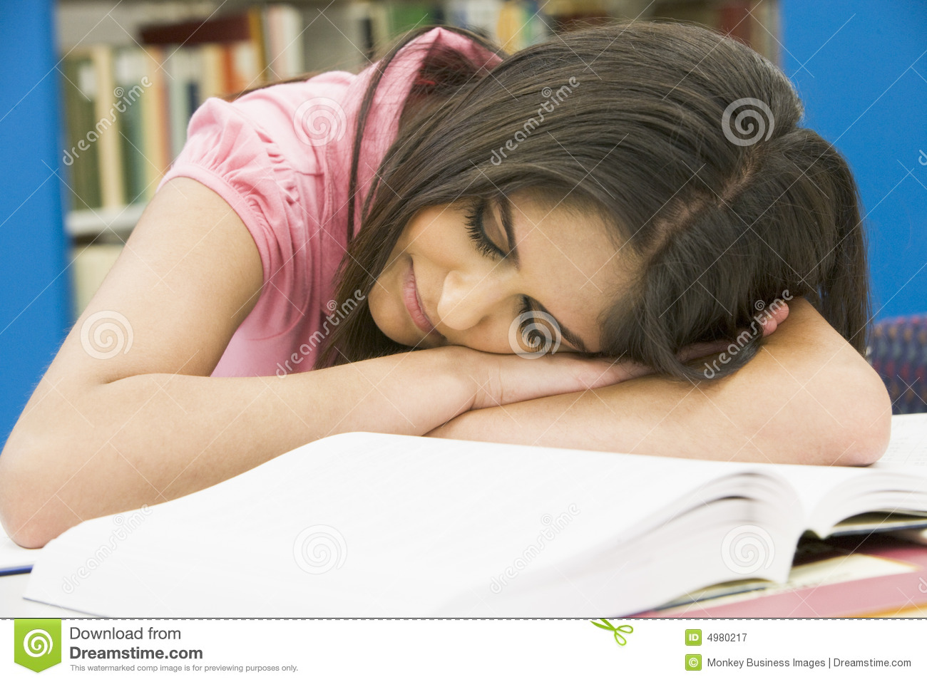 Exhausted University Student In Library Royalty Free Stock Photography