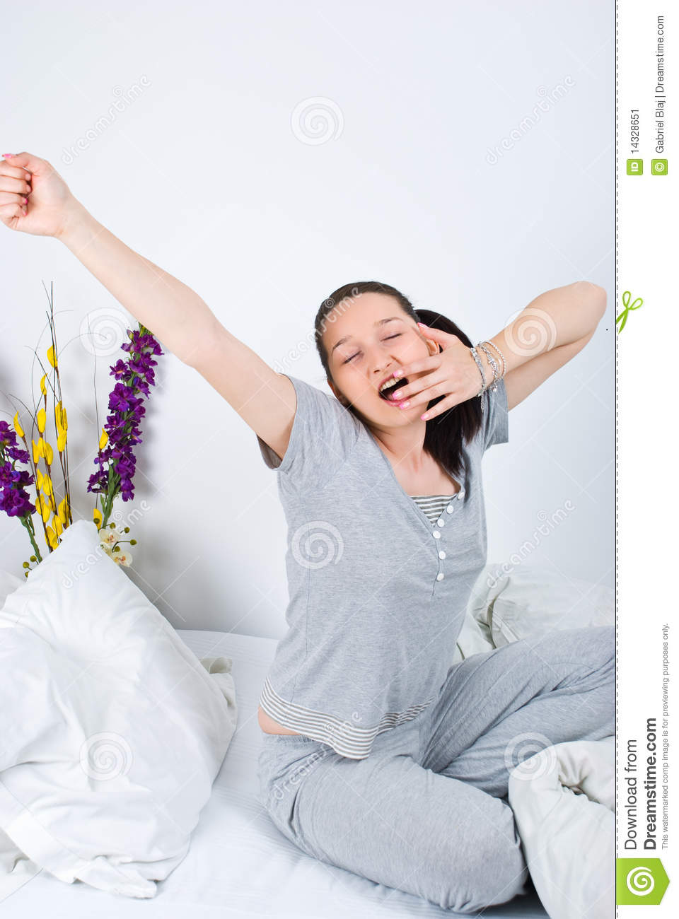 Young Woman Stretching And Yawning In The Morning Or Before Sleep On
