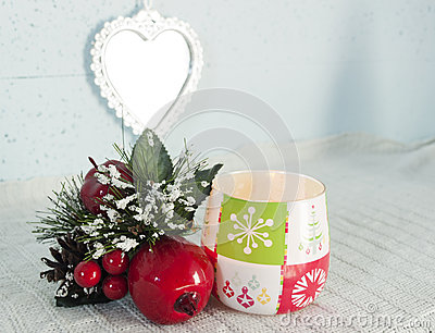Christmas Ornament And Seasonal Candle On Bright Light Background