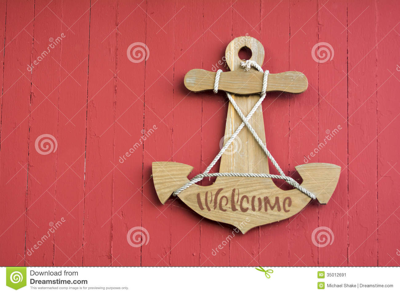     Sign In The Shape Of A Boat Anchor Hanging On A Red Wood Boat Shed