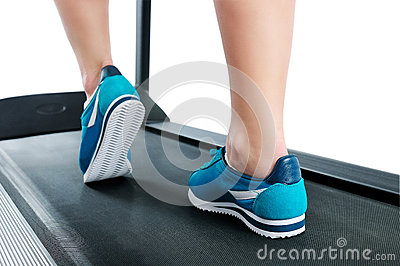 Female Legs In Turquoise Sneakers On A Treadmill  Side View