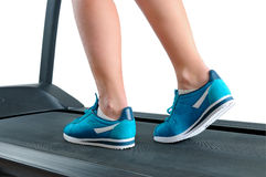     Legs In Turquoise Sneakers On A Treadmill  Royalty Free Stock Photos