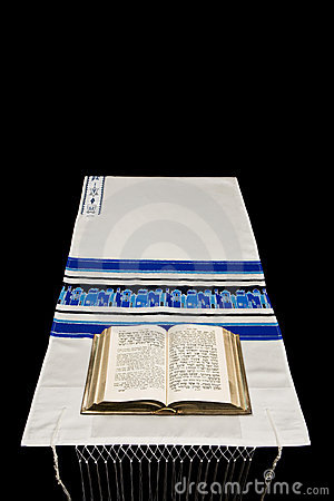 Jewish Prayer Book Or Siddur On A Prayer Shawl Or Tallit Against    