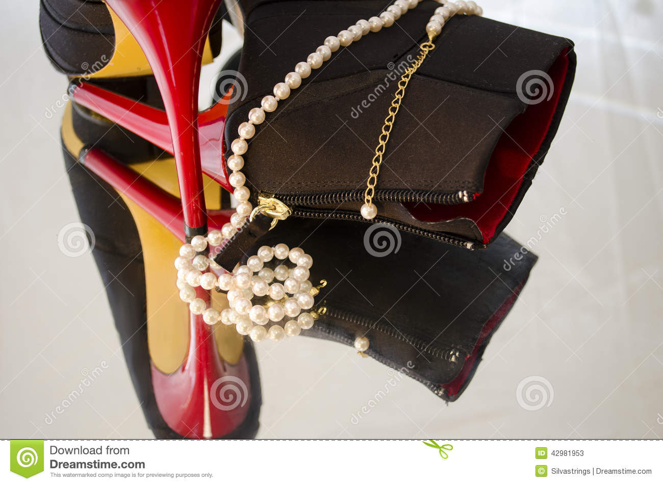 Pearl Necklace Draped Around A Pair Of High Heel Shoes