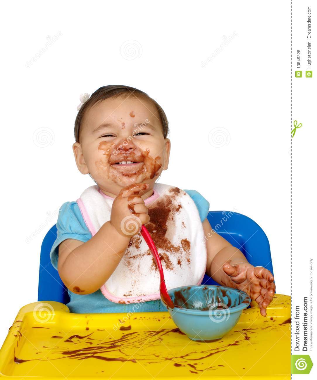 One Year Old Baby Girl Eating Chocolate Pudding With A Very Messy Face    
