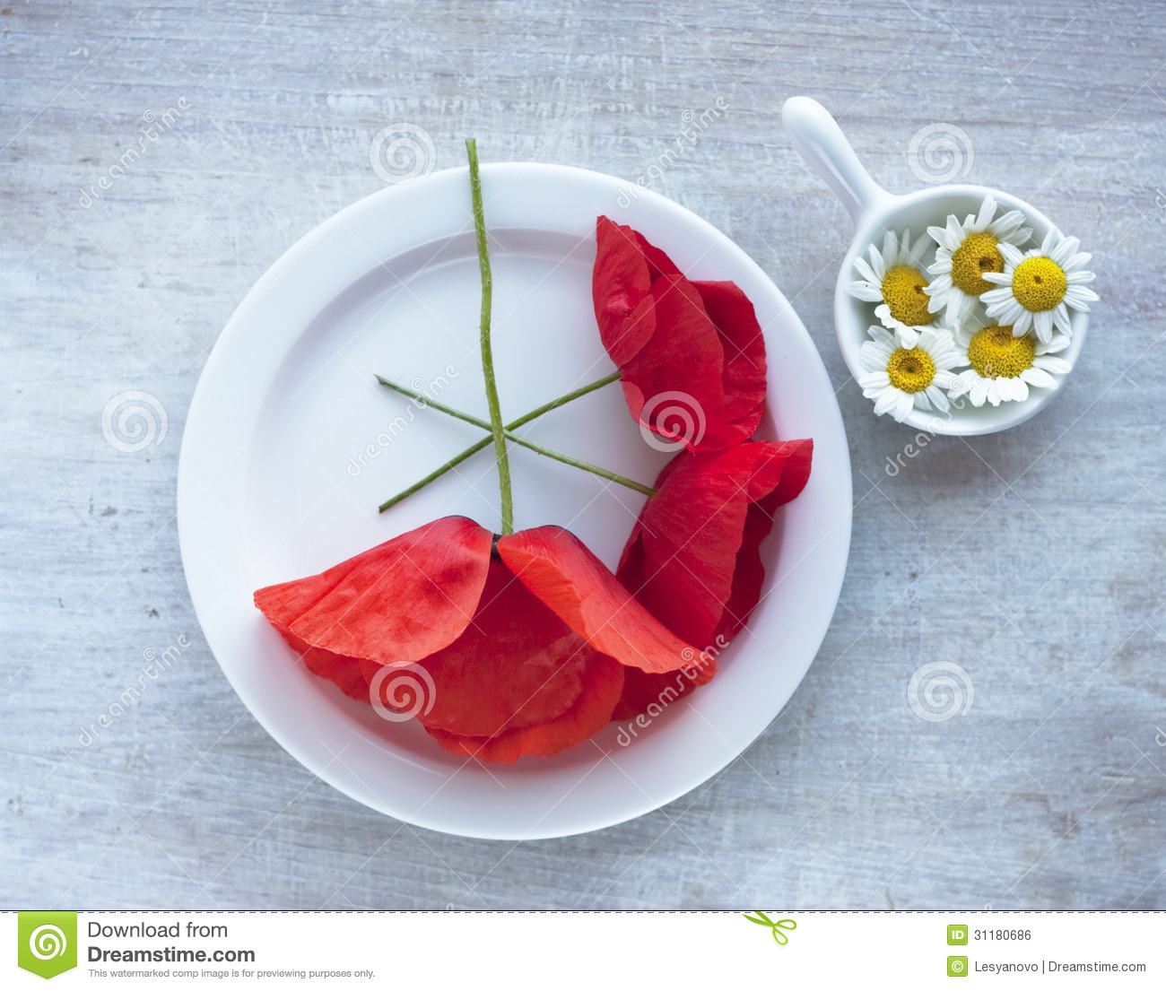     Stock Image  Camomile And Poppy In The Small Plate On The China Dishes