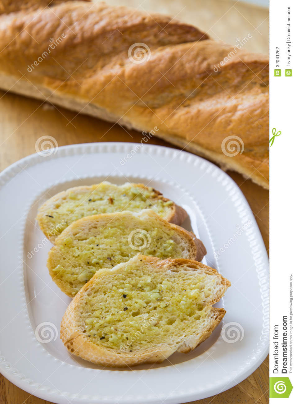 Garlic Bread With Herbs On White Bread Dish
