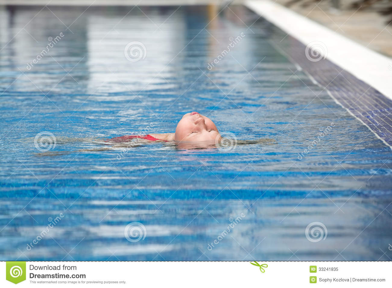Little Girl Learning To Swim The Backstroke In Outdoor Swimming Pool