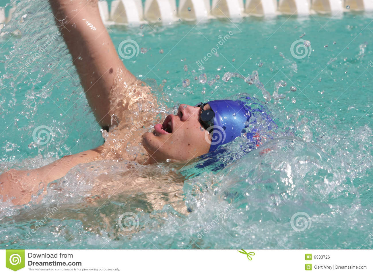 Swimmers Swimming Backstroke Event In Blue Water