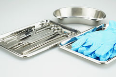 Medical Instruments And Blue Gloves In A Stainless Steel Tray Stock