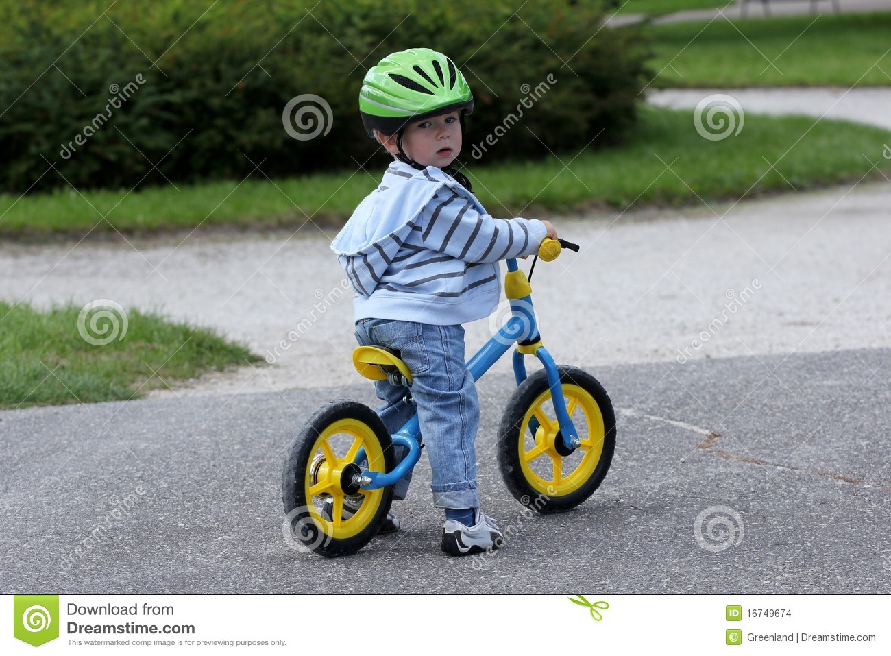 Baby Boy Riding On His First Bike In A Helmet  Child Learning To Ride