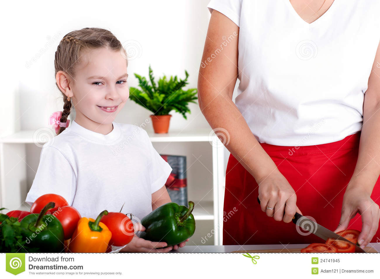 Mother And Daughter Cooking Vegetable Salad Together