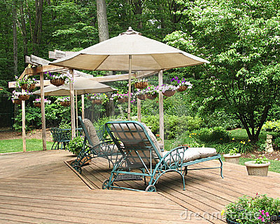 Lounge Chairs Under Patio Umbrella On Deck Decorated With Hanging    
