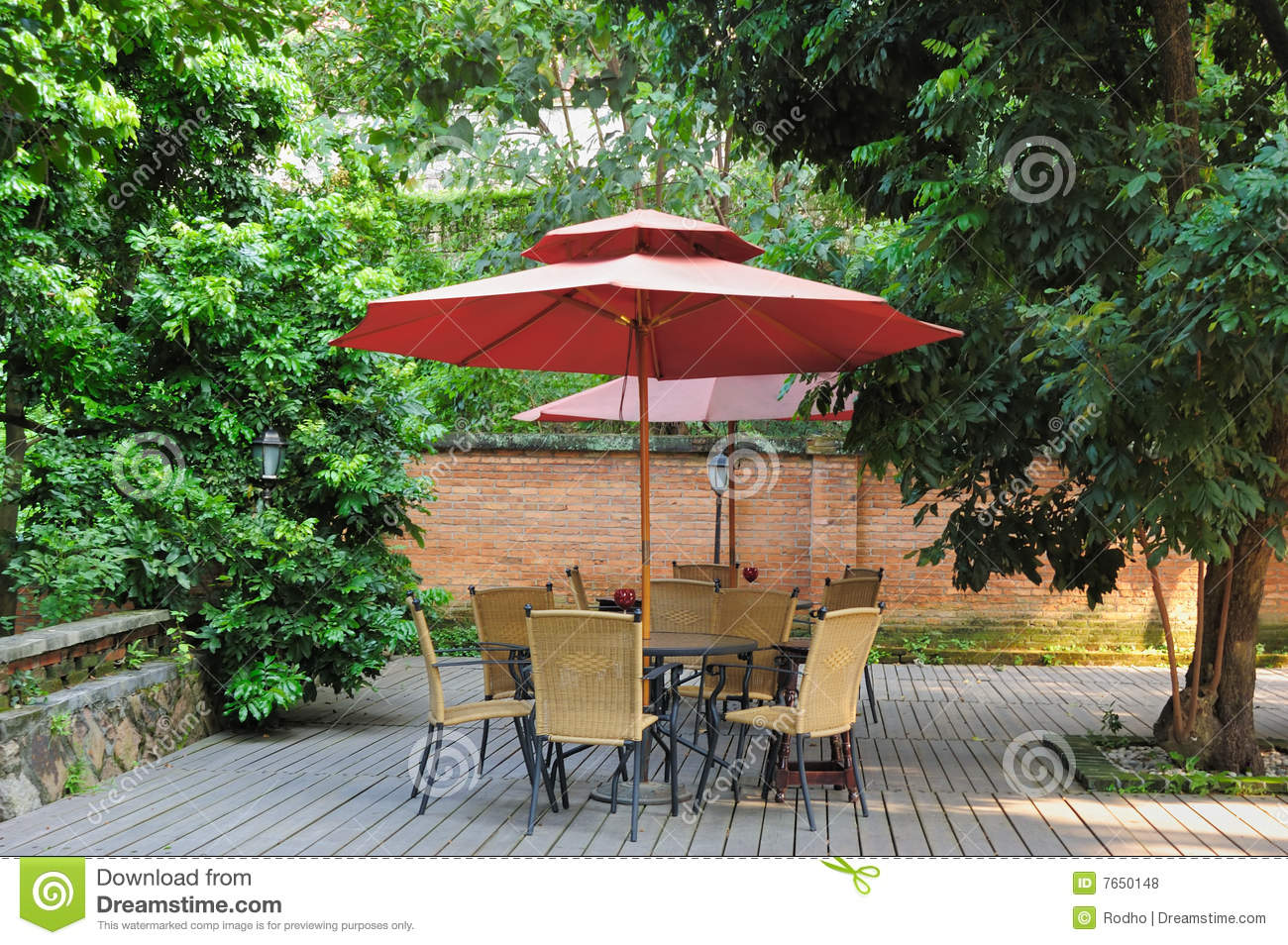 Summer Patio With Tables And Cane Chairs Under Umbrella In China