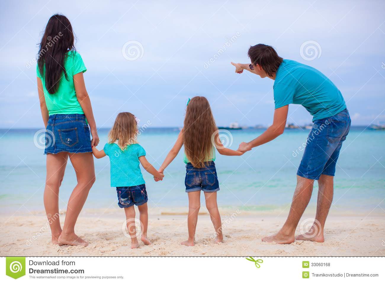 Back View Of Young Family With Two Daughters At Exotic Beach On Sunny
