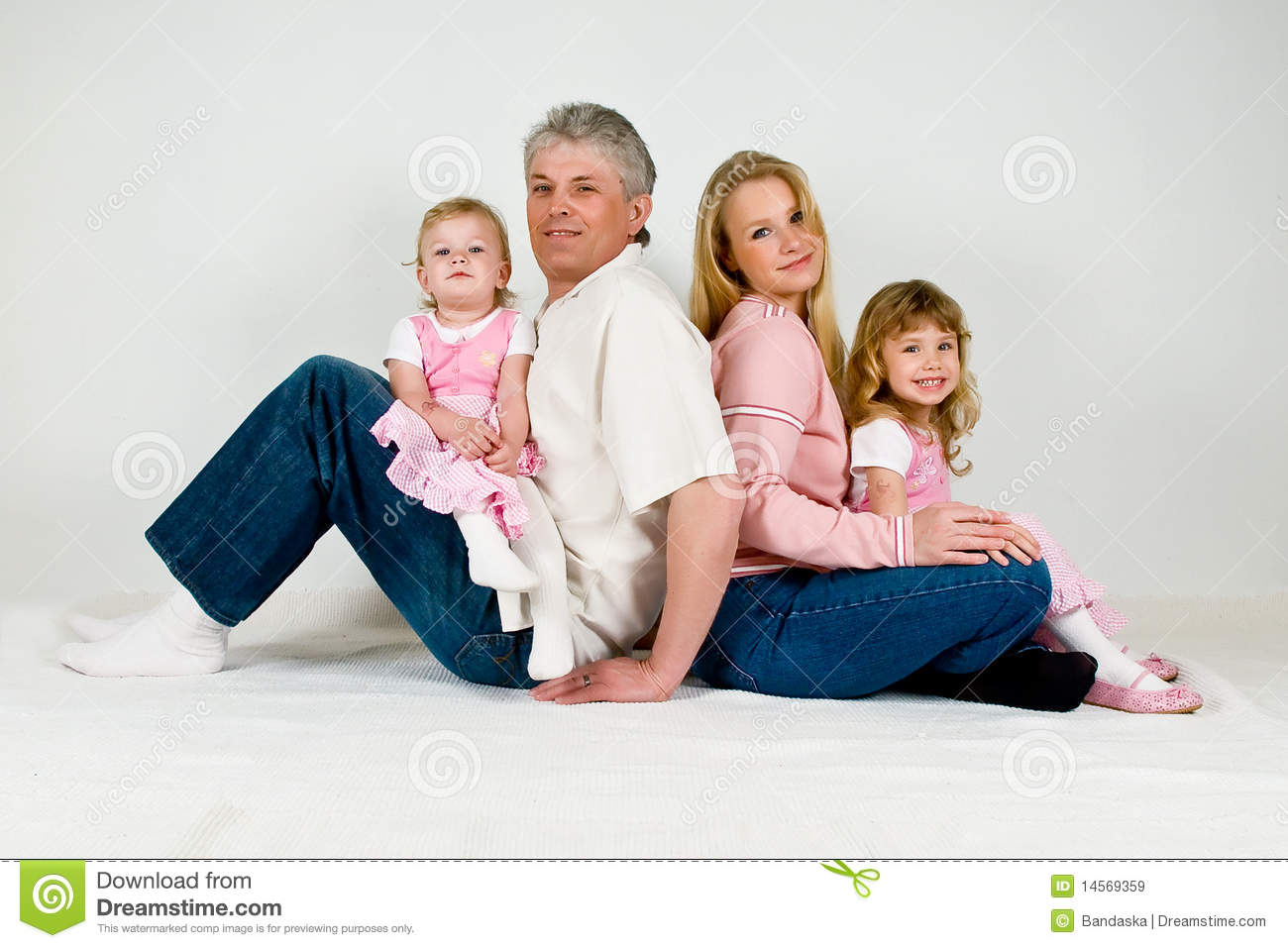 Happy Family With Two Daughters Sitting On Parent S Laps Girls Are In    