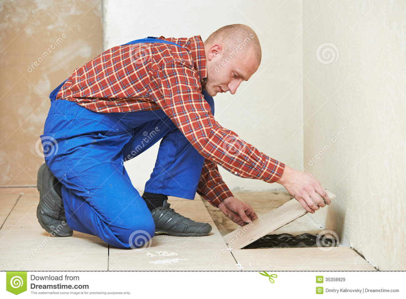 Professional Tiler Builder Worker Installing Home Floor Tile At Repair
