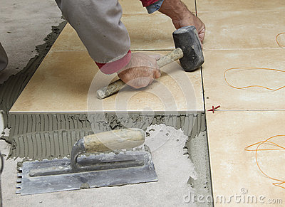 Renovation   Construction Worker Tiler Is Tiling Ceramic Tile Floor