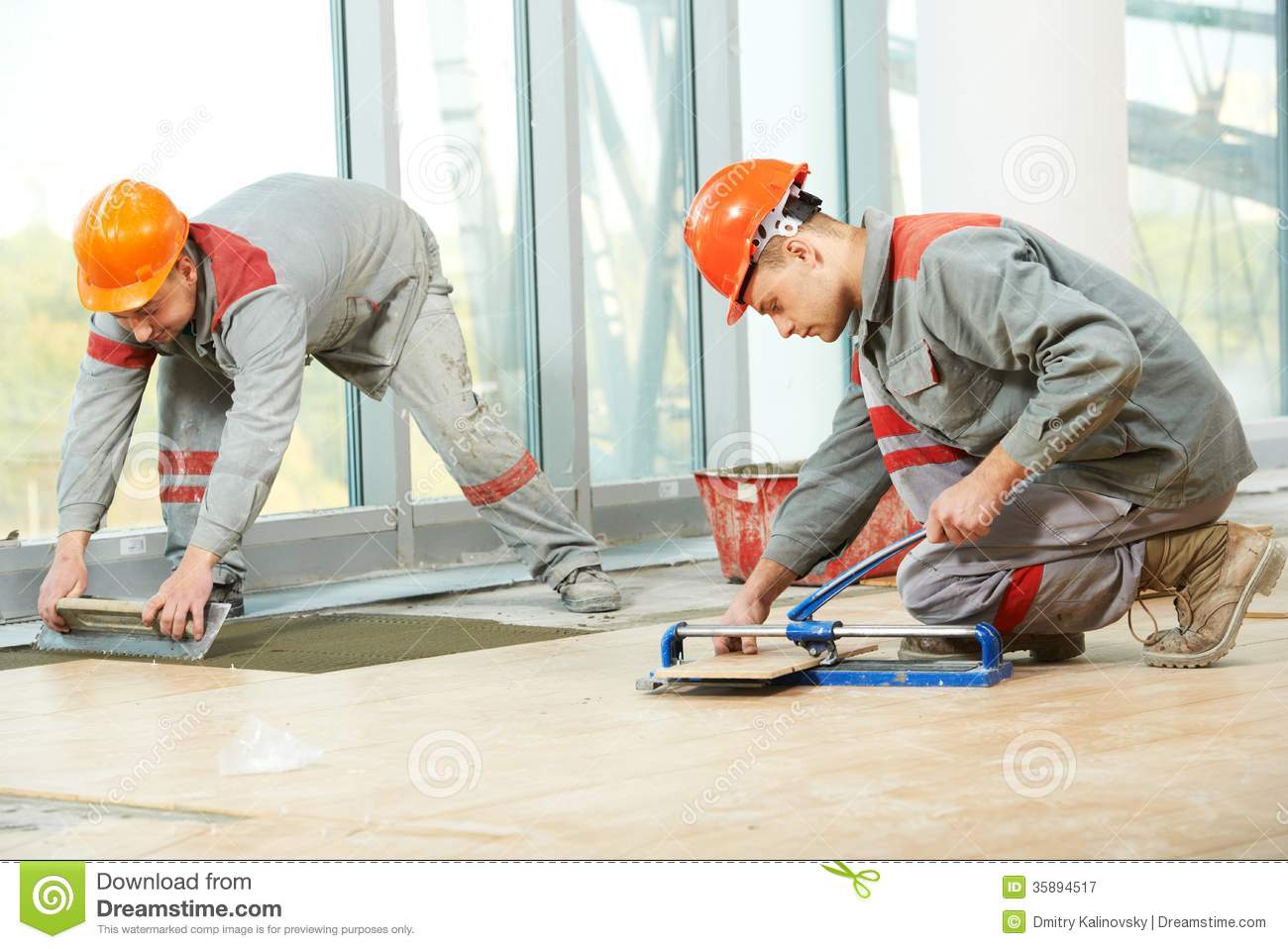 Tiler Builder Worker Installing Floor Tile At Repair Renovation Work