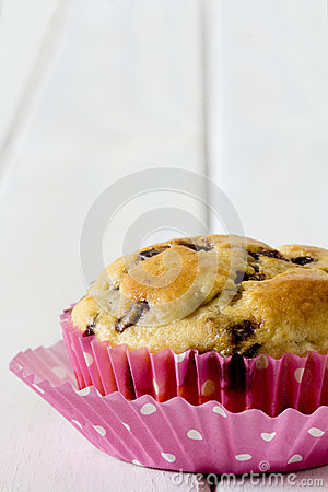 Single Chocolate Chip Muffin With Pink Polka Dot Muffin Paper On A