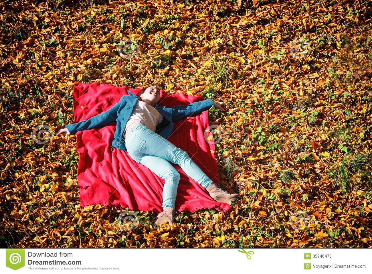 Young Girl Relaxing In Autumnal Park Lying On Red Blanket Stock Photos    