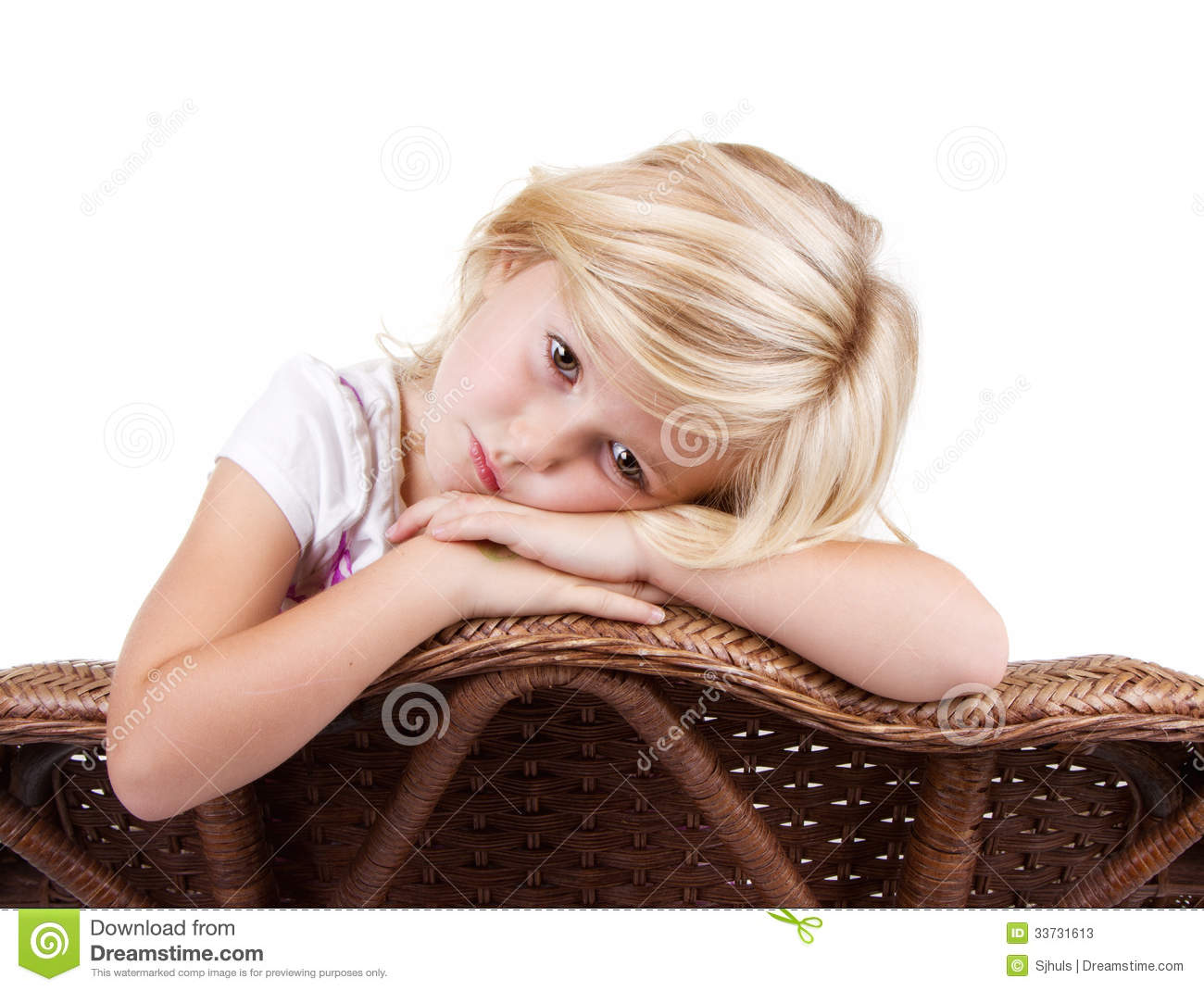 Little Girl Sitting In Chair With A Sad Or Lonely Look On Her Face    