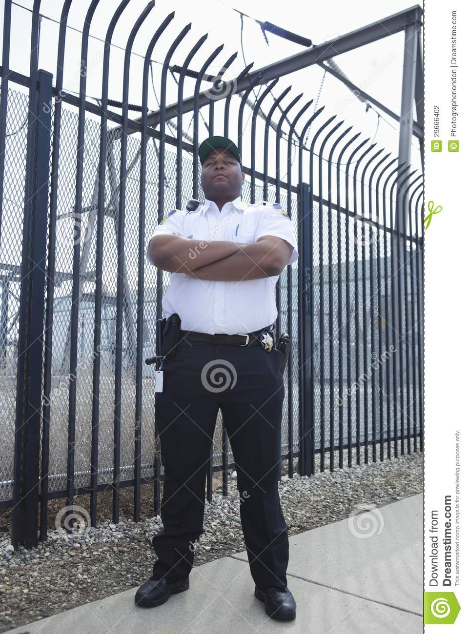 Security Guard Standing In Front Of Prison Fence Stock Photography