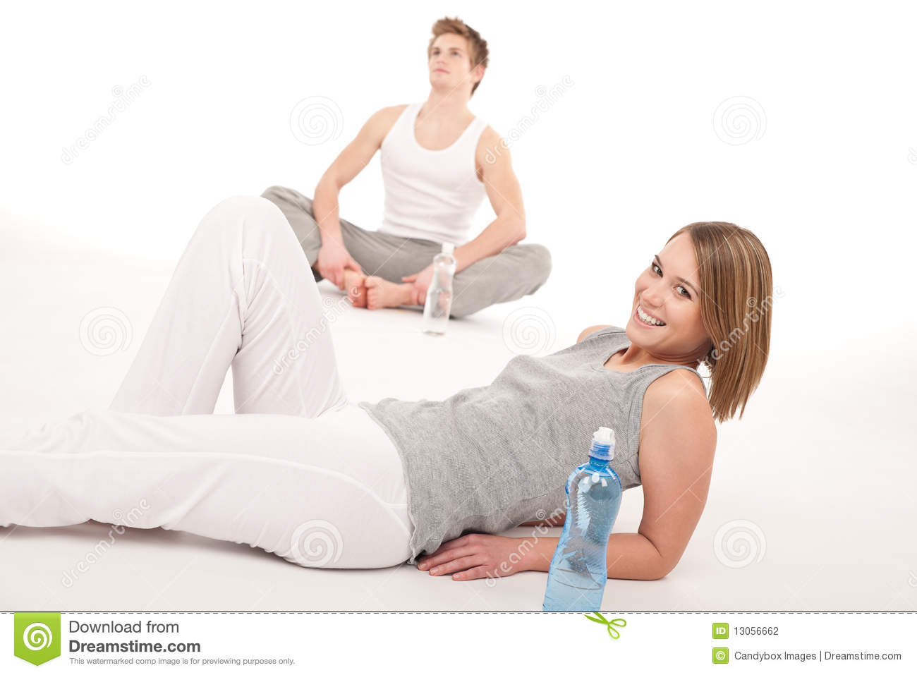 Fitness   Healthy Couple Stretching After Training On White Background