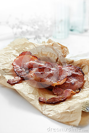 Grilled Smoked Bacon Rashers On Grease Proof Paper In Bright Morning    