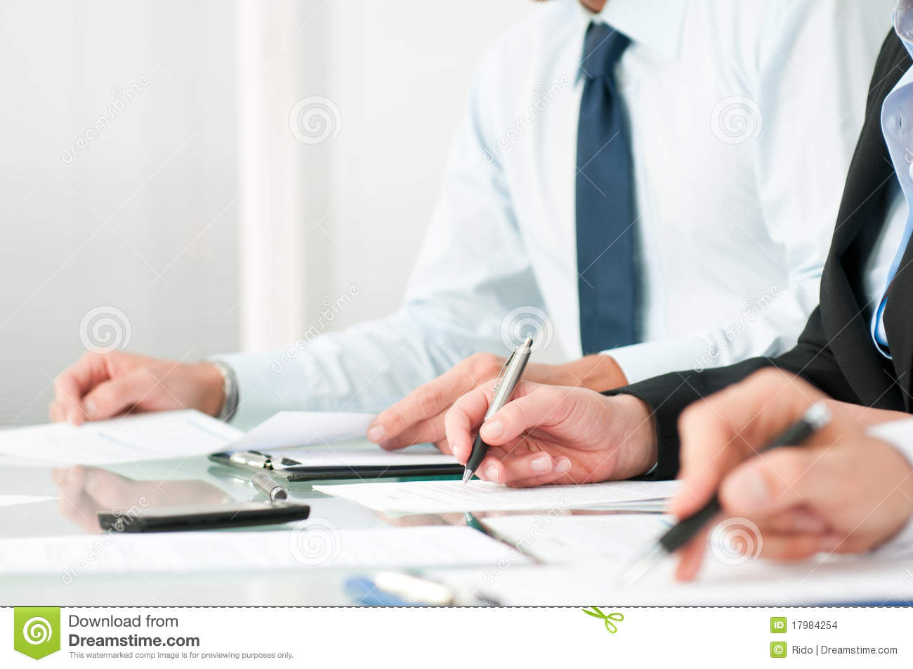 Close Up Shot Of People Compiling Forms During A Business Conference