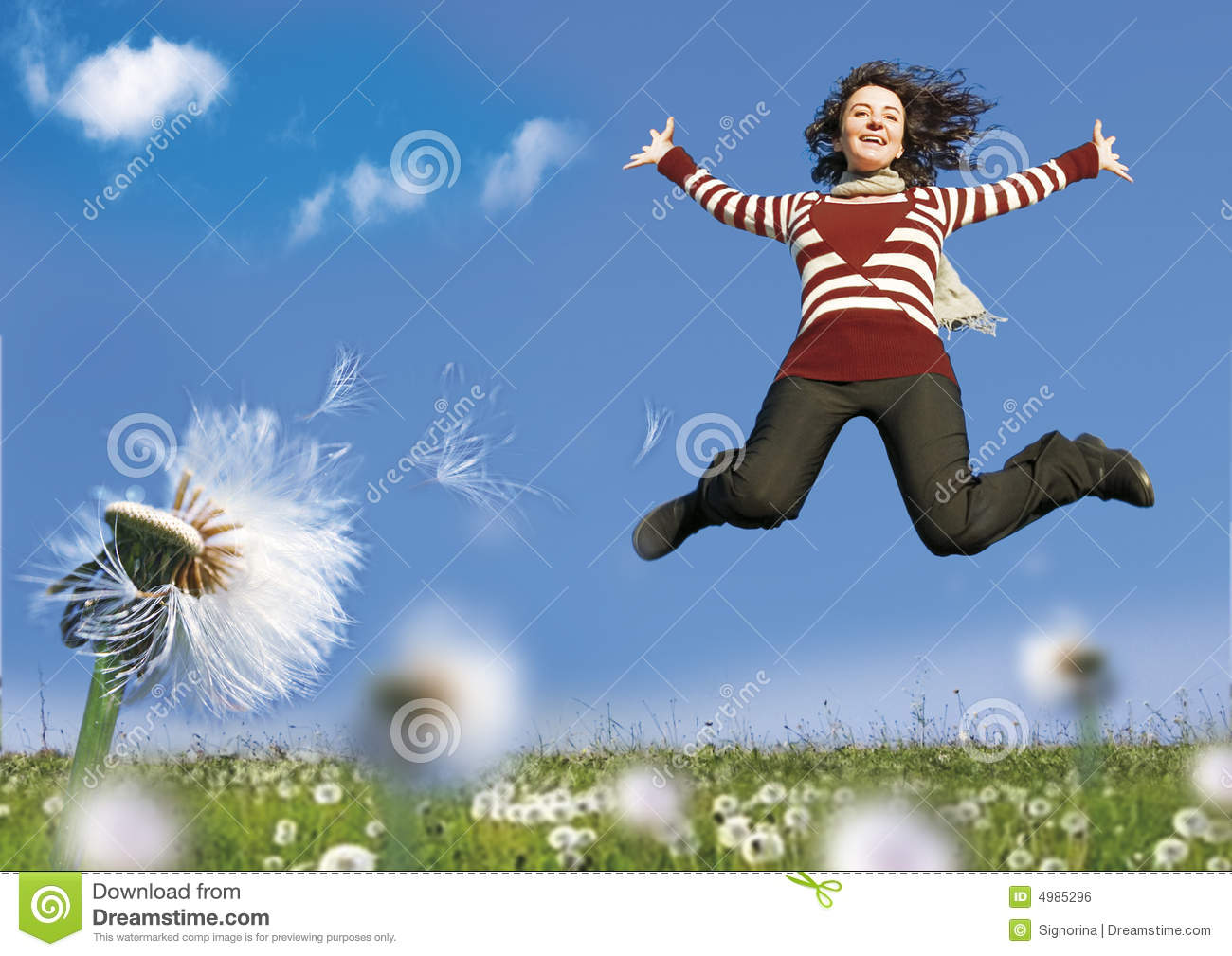 Girl Jumping In A Meadow With Dandelions 