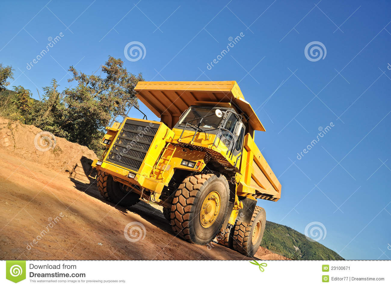 Tipper Truck Near Construction Site With Hill Covered By Forest In