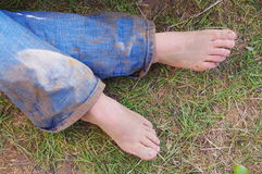 Woman With Bare Feet And Muddy Jeans Stock Images