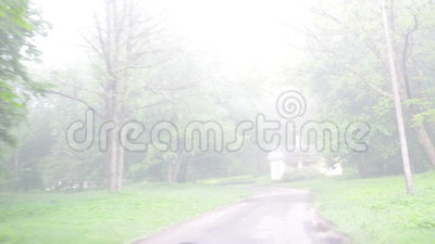 Driving Car In Park Road Amazing Dense Fog Cover Trees And House Stock    