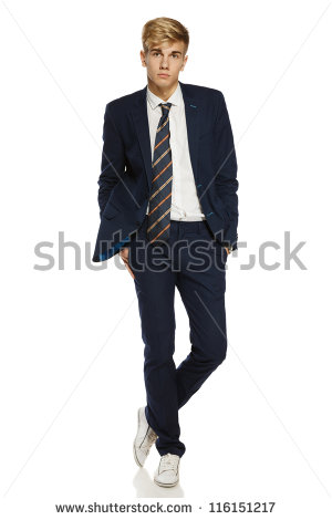 Of A Stylish Young Man Standing Posing In Suit Over White Background