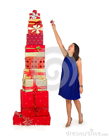 Putting One Little Gift On Top Of A Huge Stack Of Christmas Presents