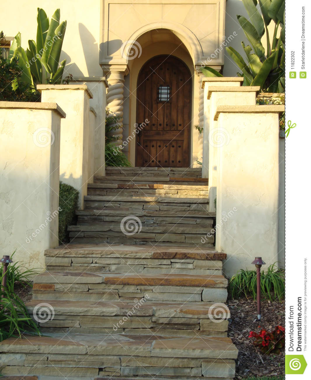 Slate Steps Leading Up To A Beautiful Arched Entry Way And Front Door