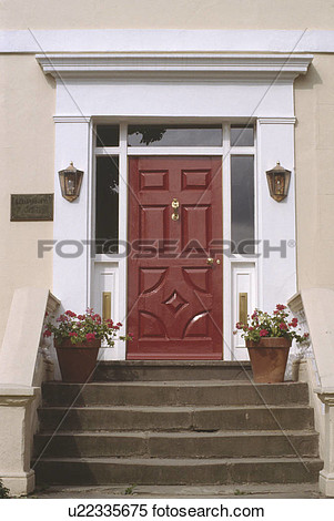 Steps Leading Up To Red Geraniums In Pots On Either Side Of Front Door