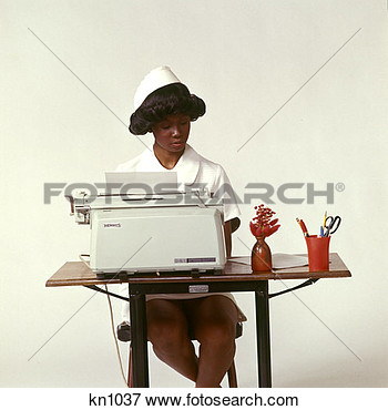 1970 1970s African American Woman Nurse Seated Desk Typewriter Typing    