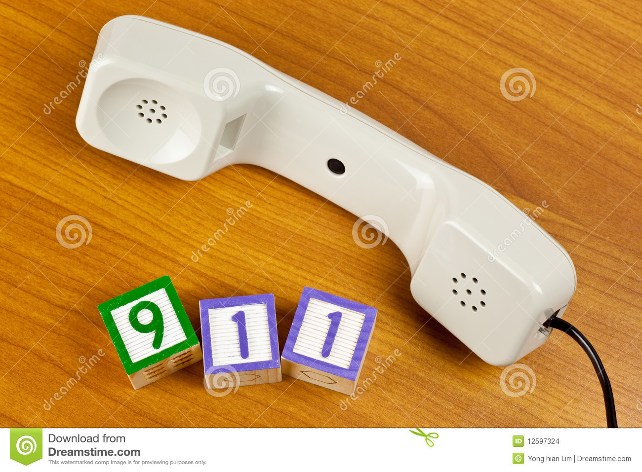 Phone Handset With Number Blocks 911 On A Table