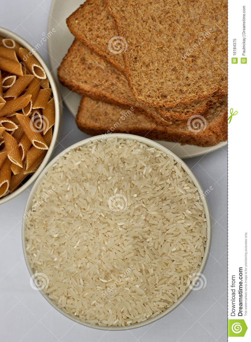 White Rice And Wholewheat Pasta In Small Bowls With 3 Slices Of    