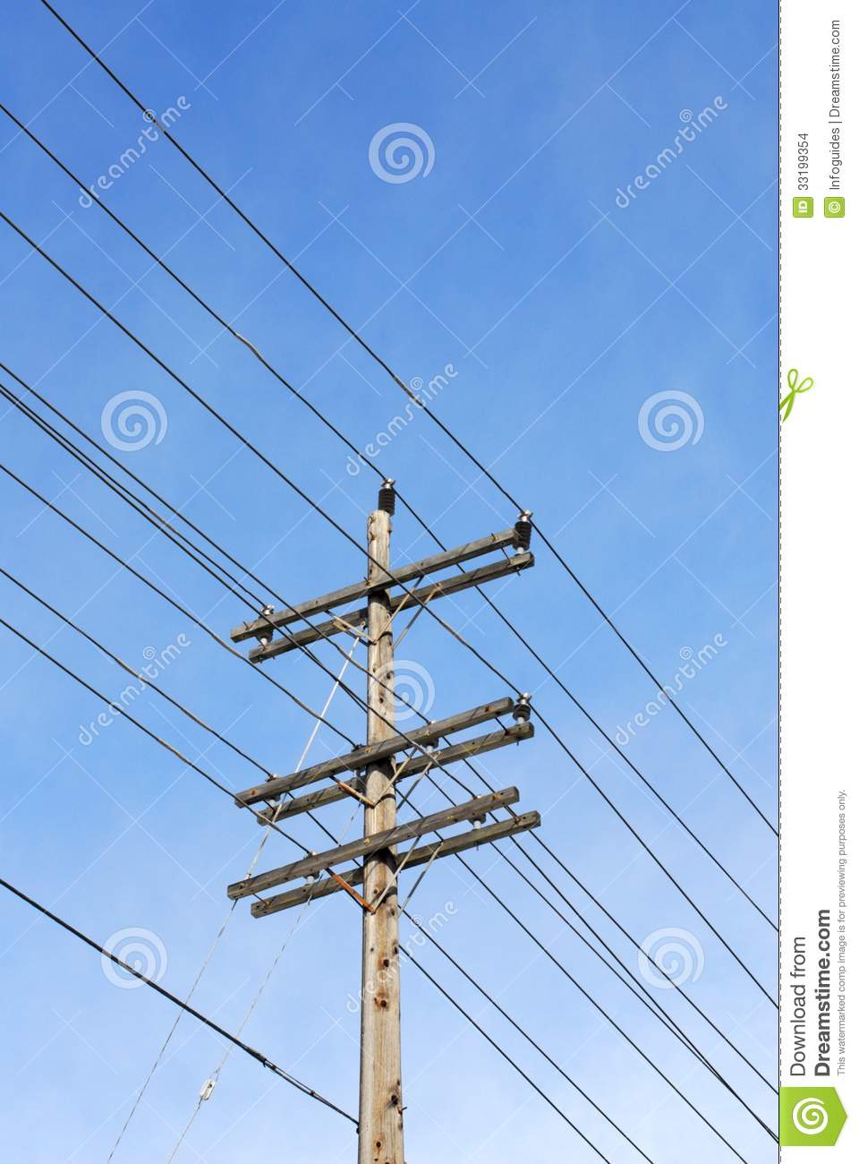 Wooden Electrical Transmission Pole And Power Lines Against Sky